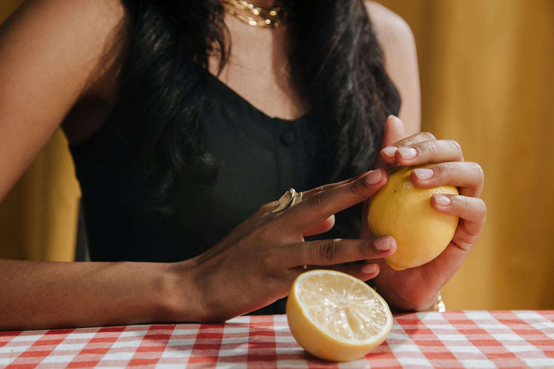 Two fresh lemons held gently in cupped hands, symbolizing careful handling and sensitivity