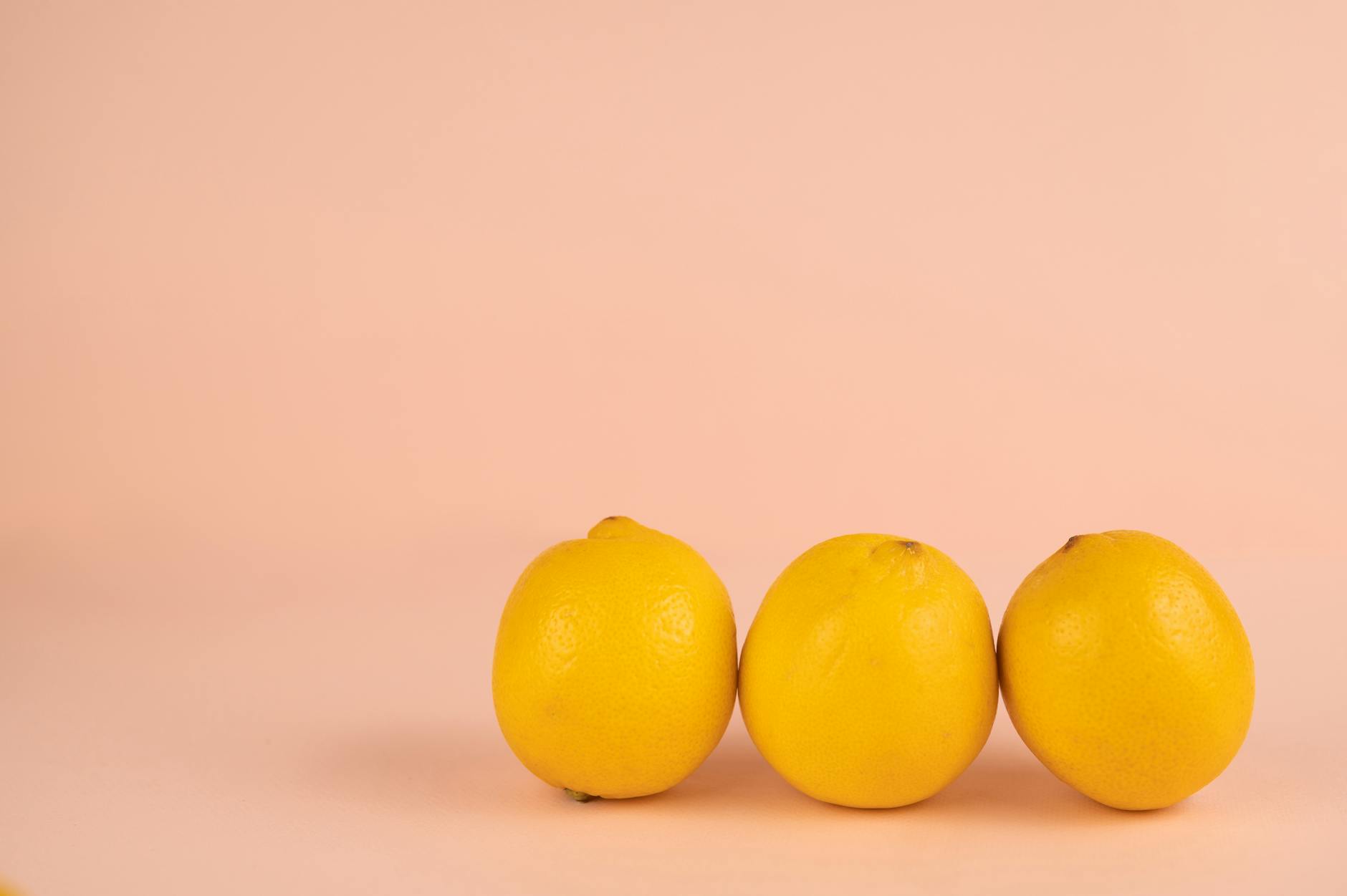 Fresh bright lemons on a pastel background, symbolizing renewal and vitality